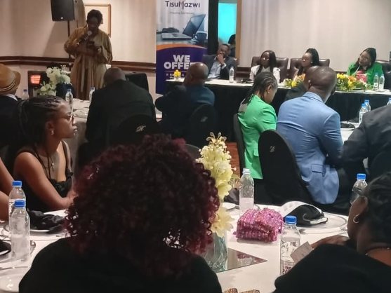 Delegates seated at round tables for a TisuMazwi refresher seminar.